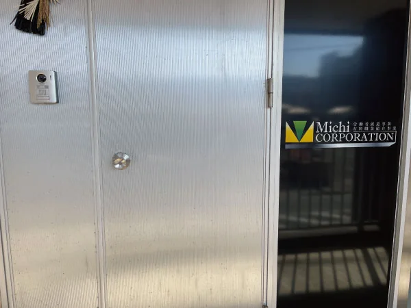 ２階の通路にあるMichi株式会社の表示が付いた事務所の入口